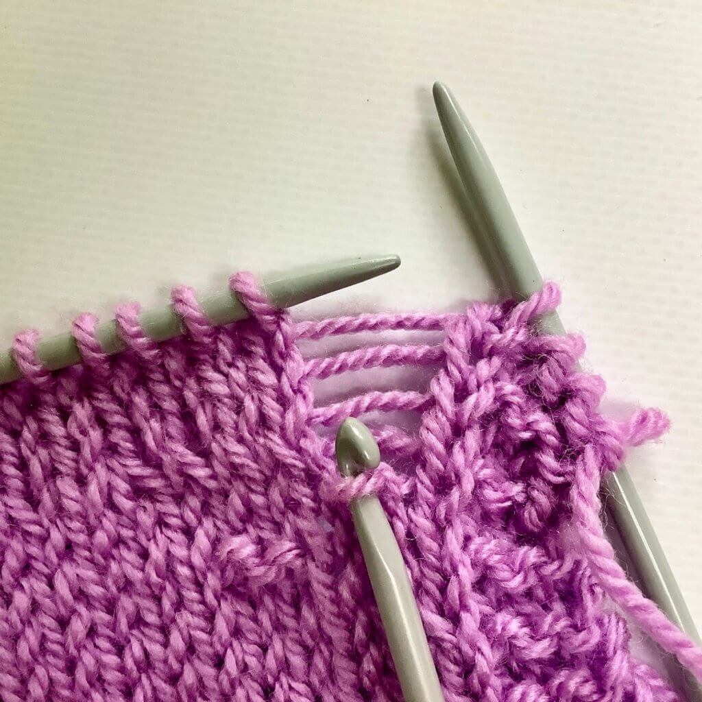 Catch the wayward stitch with your crochet hook.