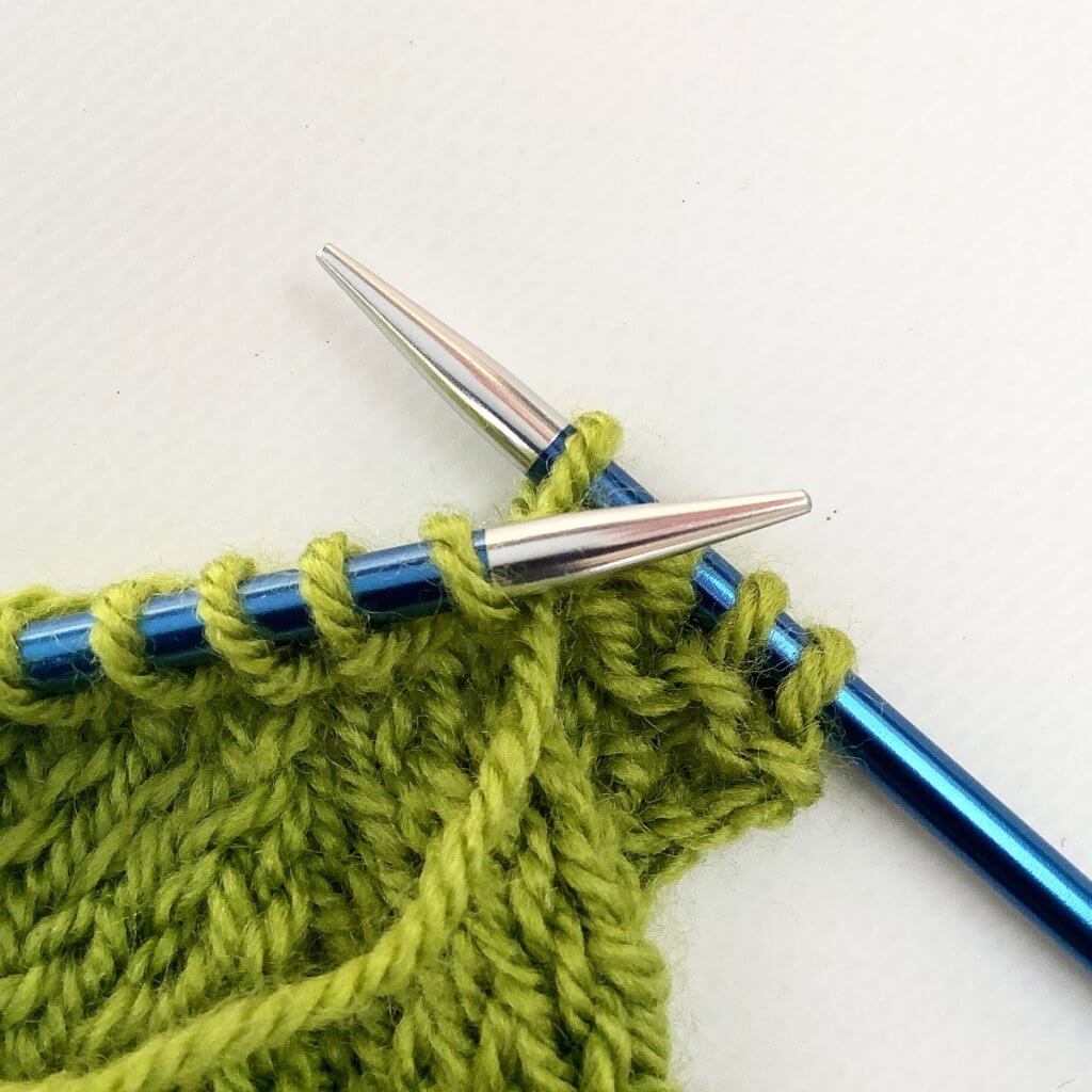 Step 2 in working a purl-side left-leaning lifted increase