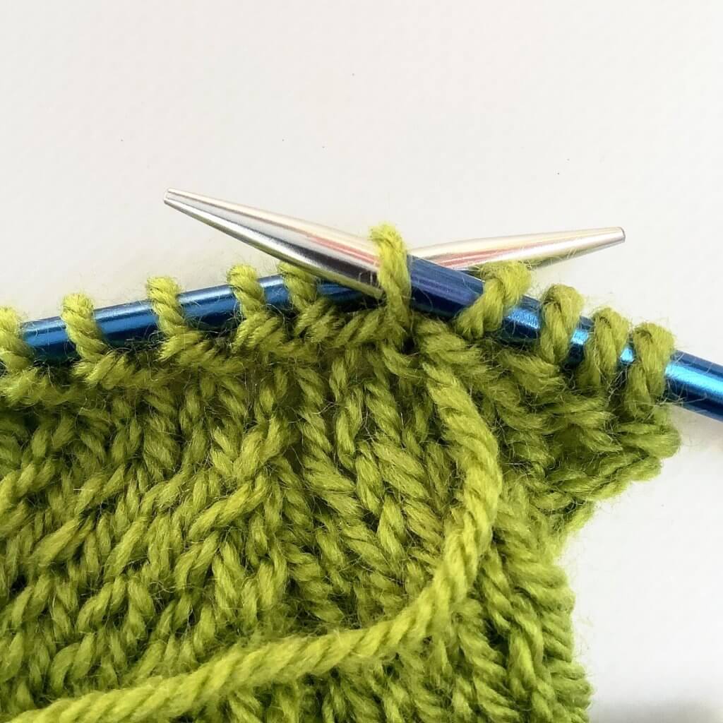 Step 3 in working a purl-side left-leaning lifted increase