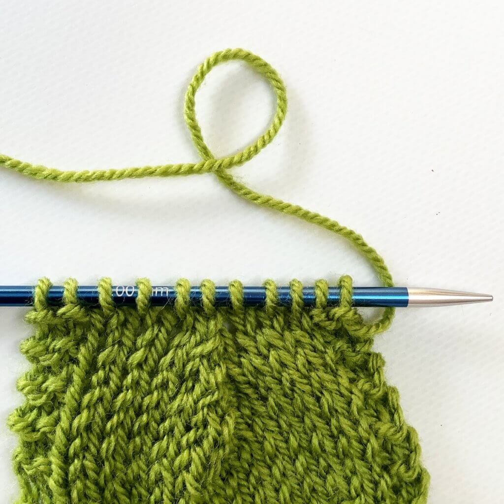 The k3tog right-leaning double decrease used in several rows.