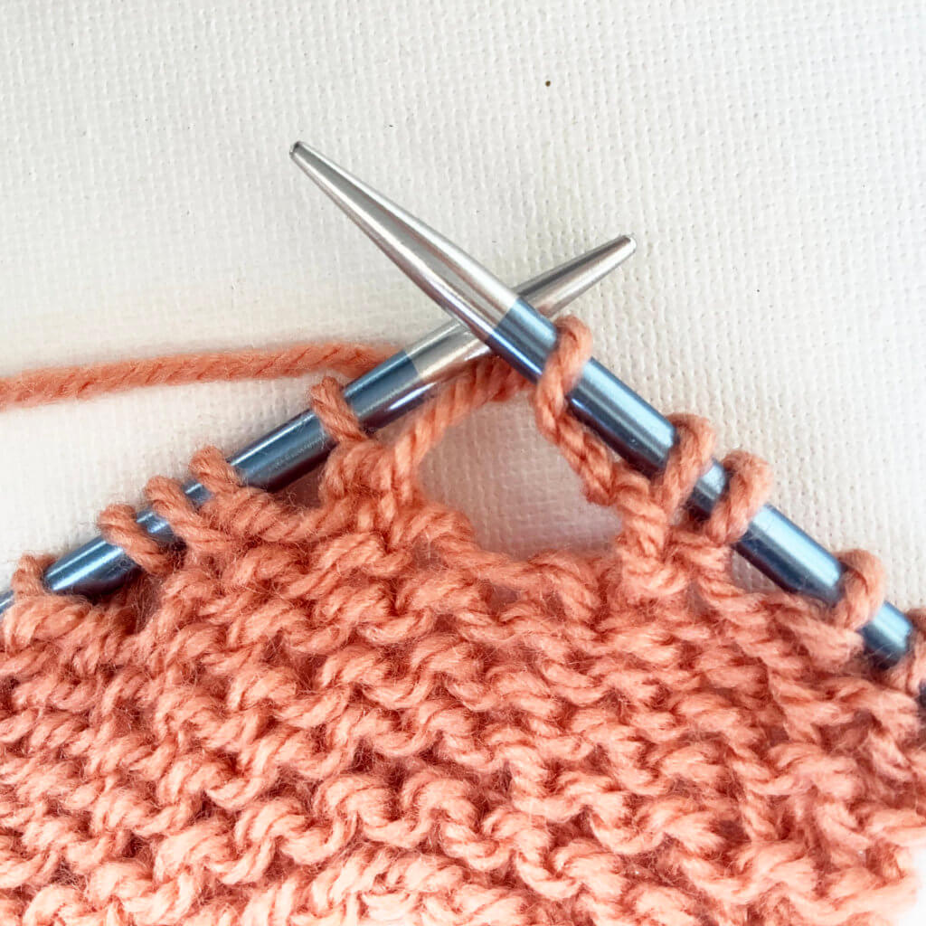 Next, knit in to the double yo loop