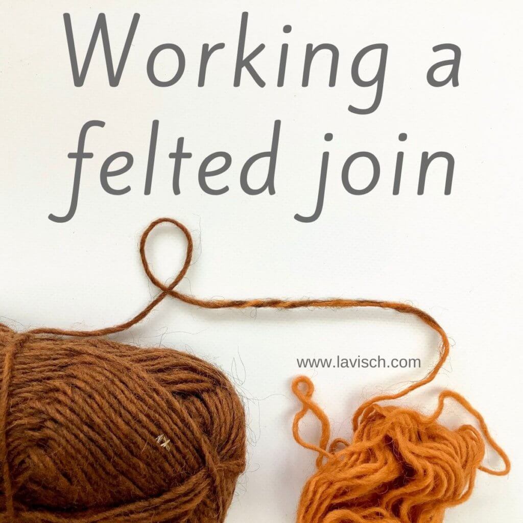 A ball of orange and brown yarn on a white background, joined together with a felted join.