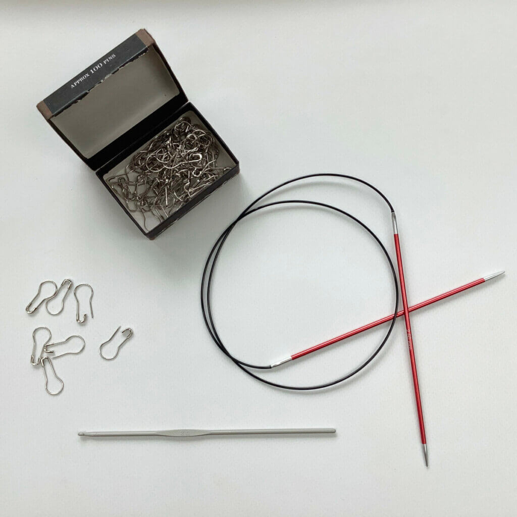 Bulb pins, a circular knitting needle and a crochet hook.