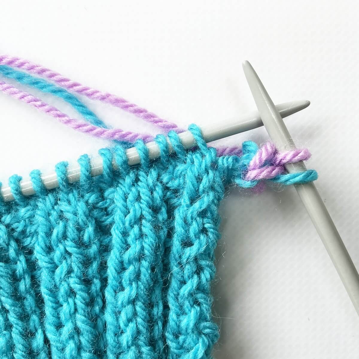 Step 11 of working a Vikkel braid in a contrasting color