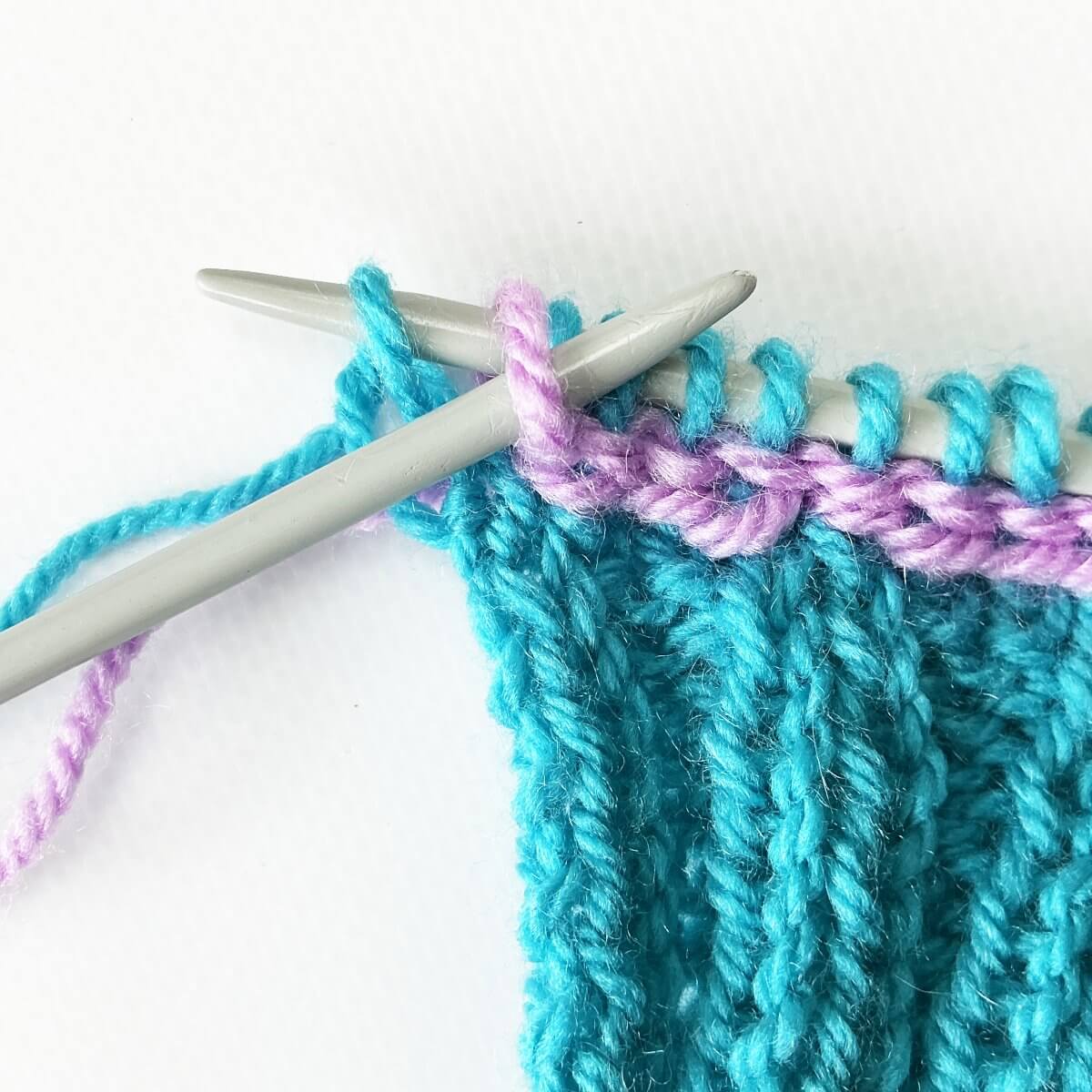 Step 15 of working a Vikkel braid in a contrasting color