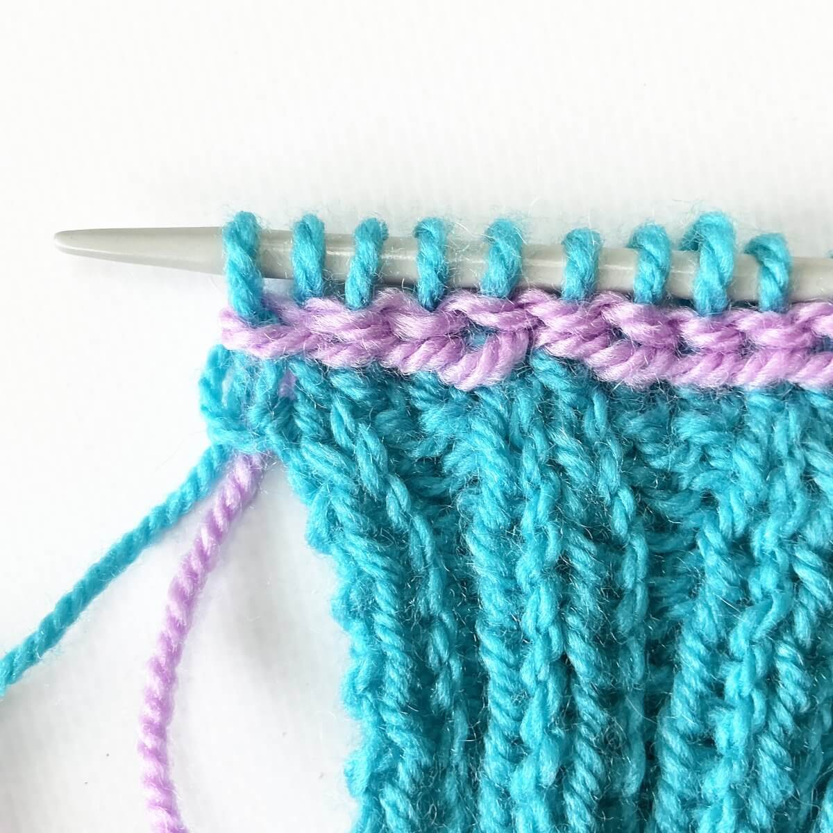 Step 16 of working a Vikkel braid in a contrasting color