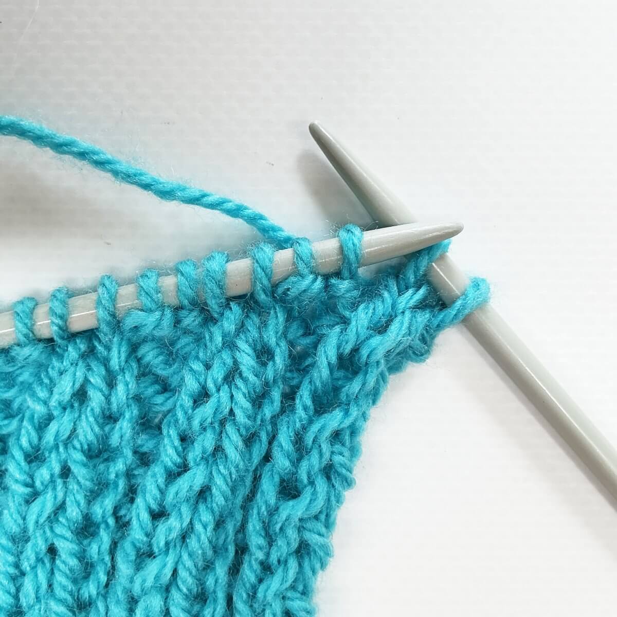 Working the stretchy YO bind-off for 2x2 rib, step 3