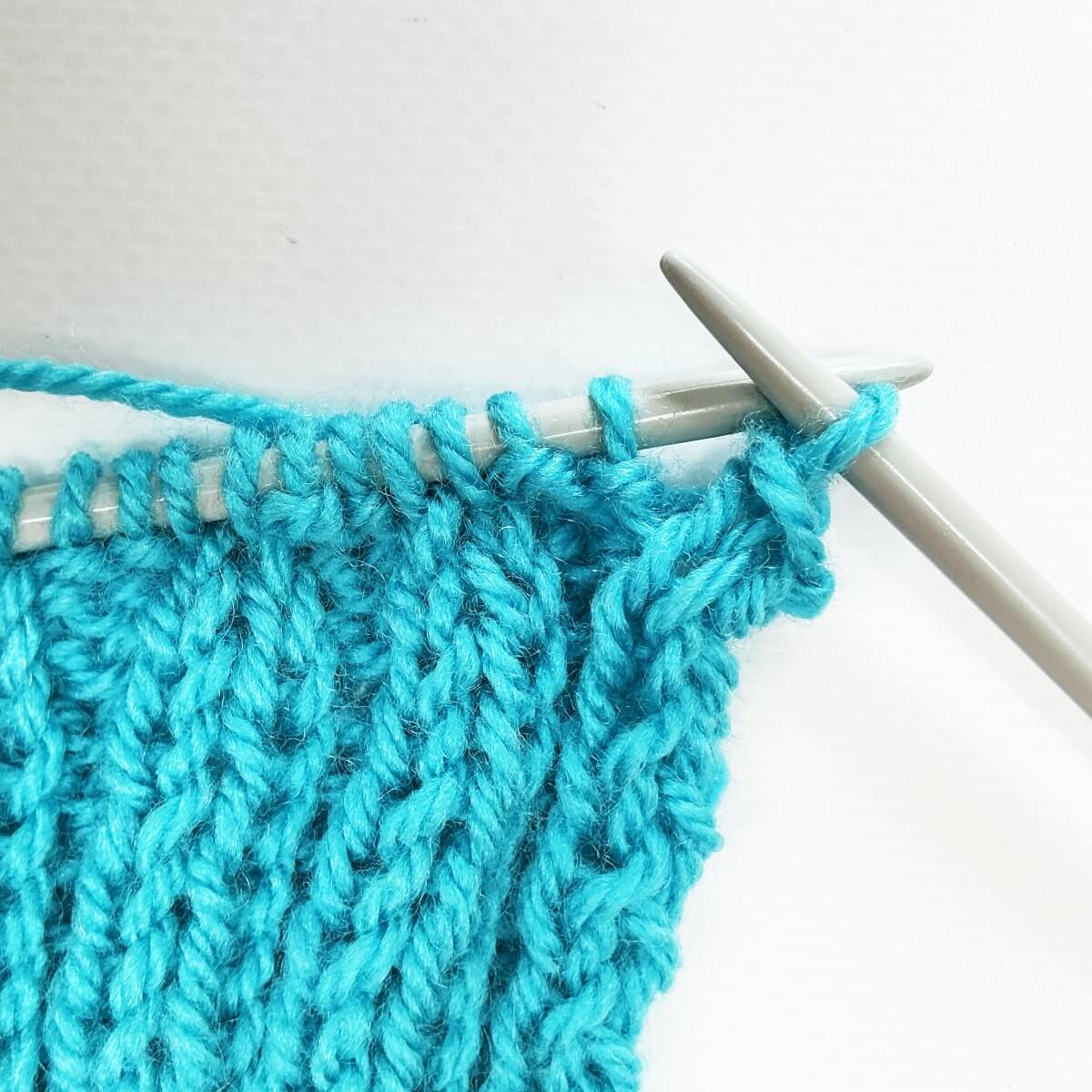 Working the stretchy YO bind-off for 2x2 rib, step 5