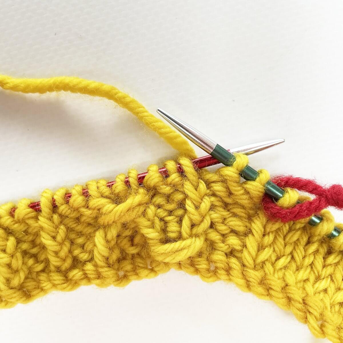 Step 1 of working the (k tbl, yo, skp, k tbl) wrapped twice stitch