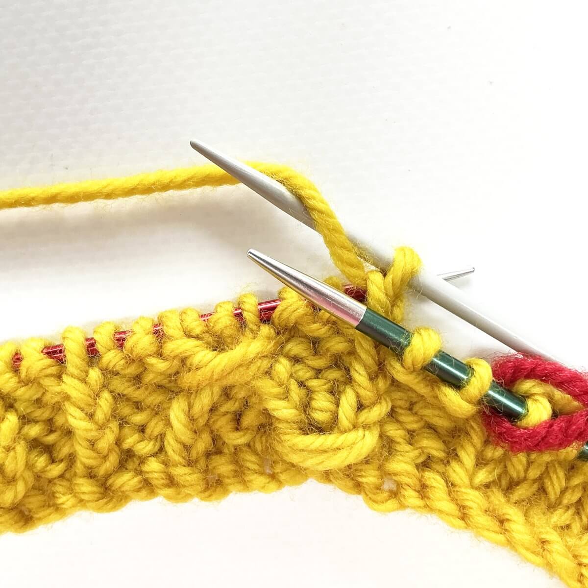 Step 3 of working the (k tbl, yo, skp, k tbl) wrapped twice stitch