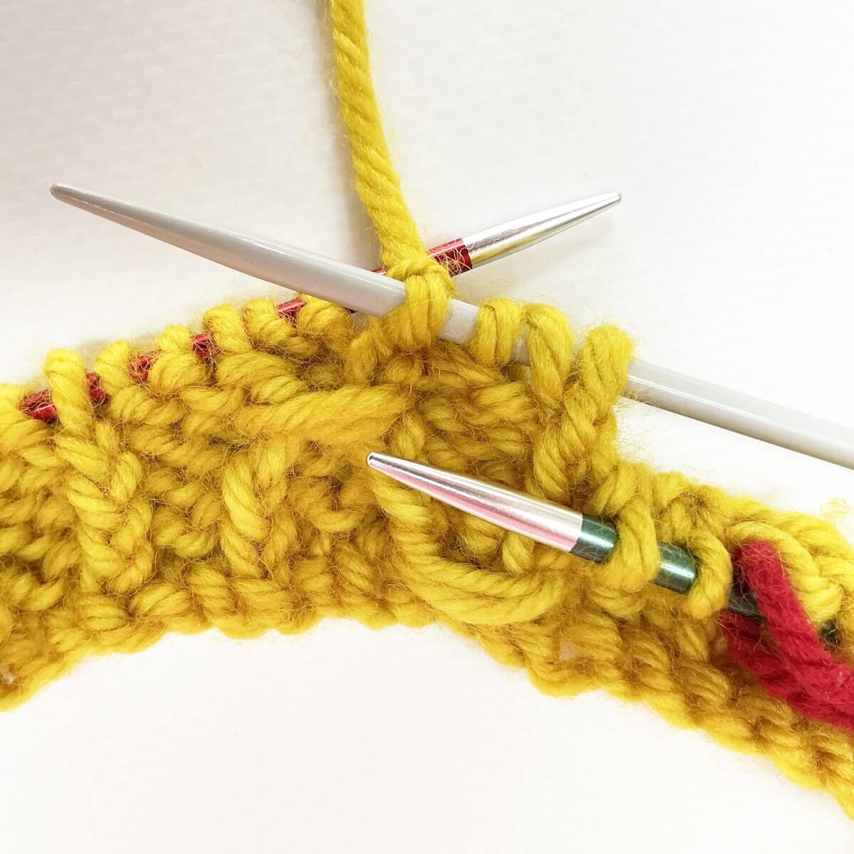 Step 5 of working the (k tbl, yo, skp, k tbl) wrapped twice stitch