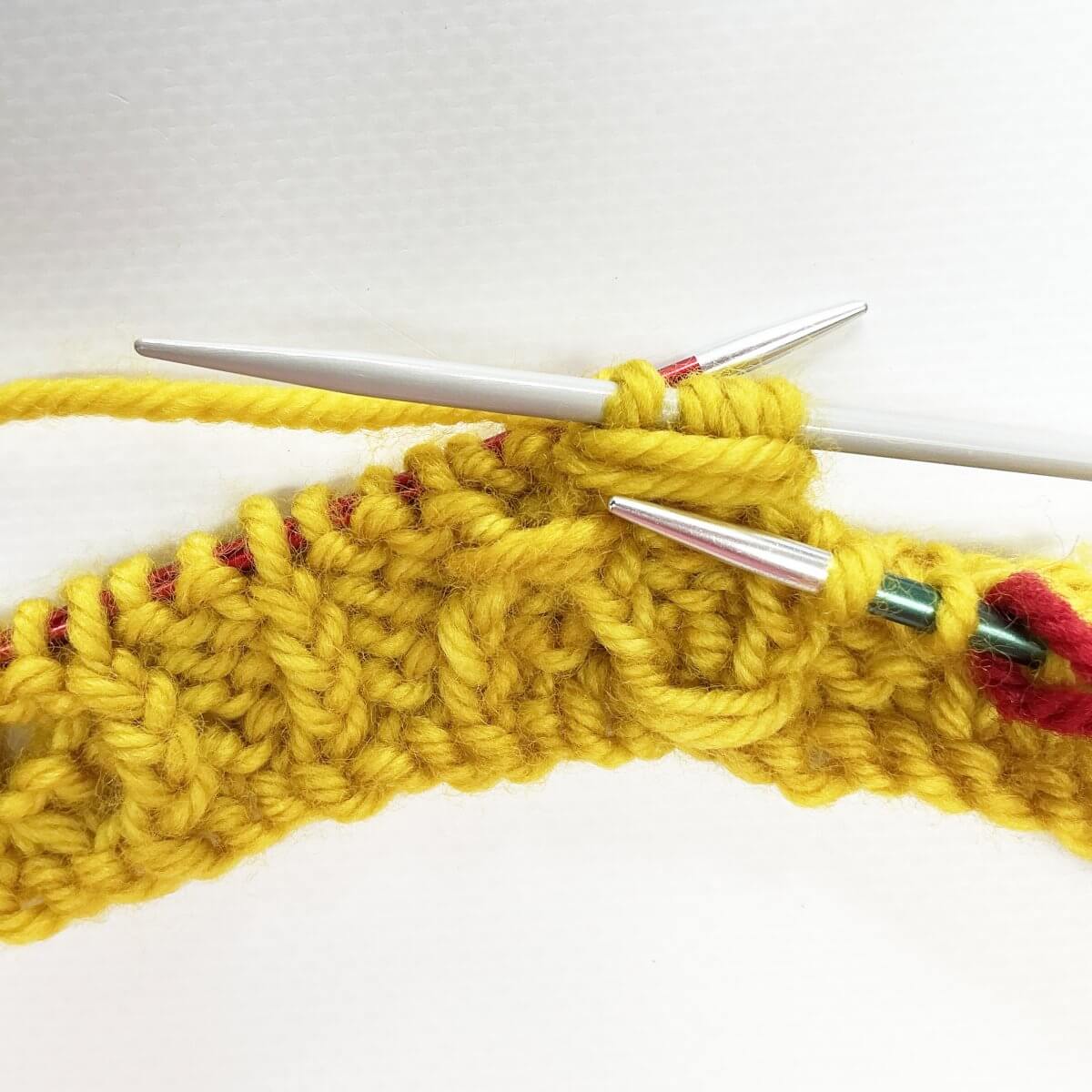 Step 7 of working the (k tbl, yo, skp, k tbl) wrapped twice stitch
