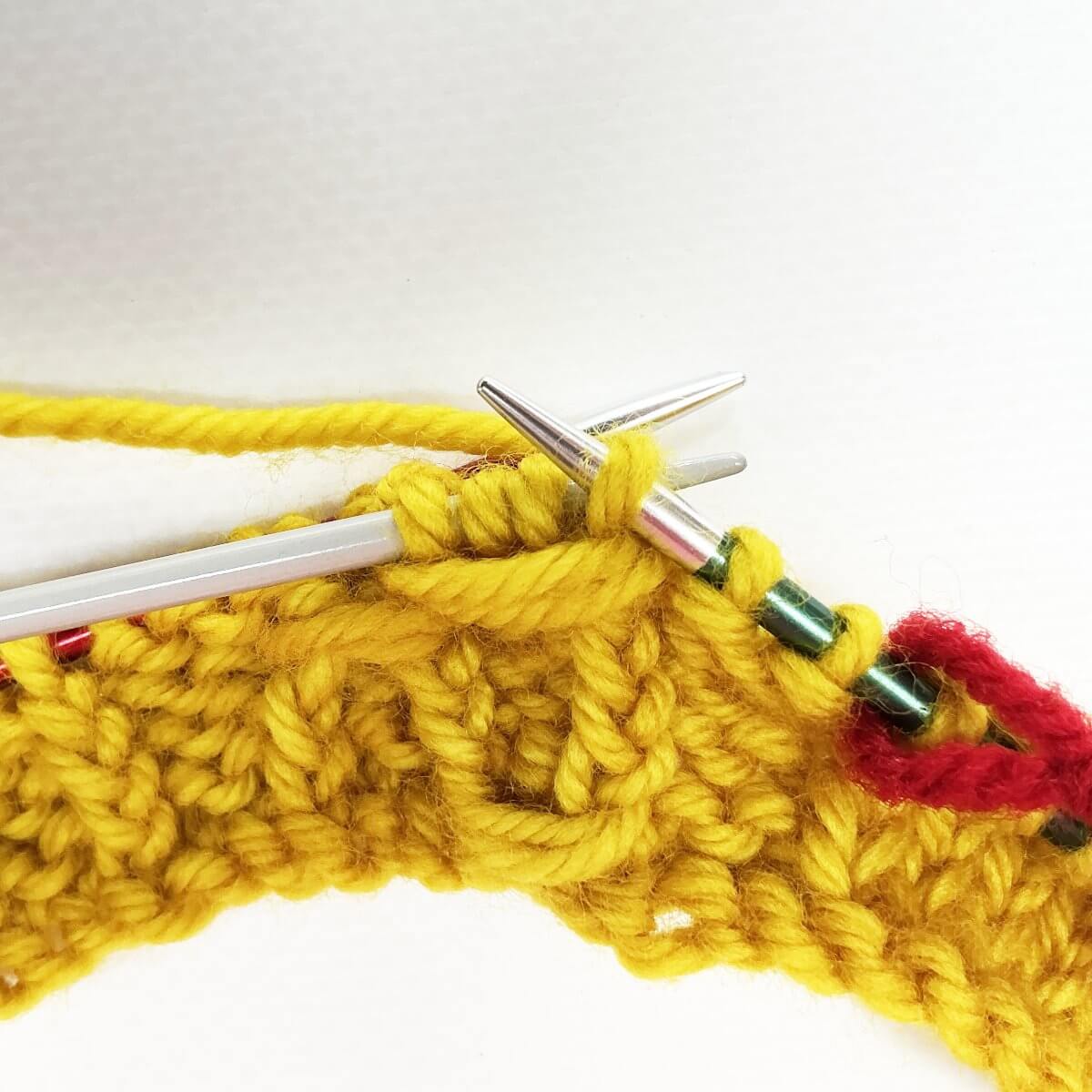 Step 8 of working the (k tbl, yo, skp, k tbl) wrapped twice stitch