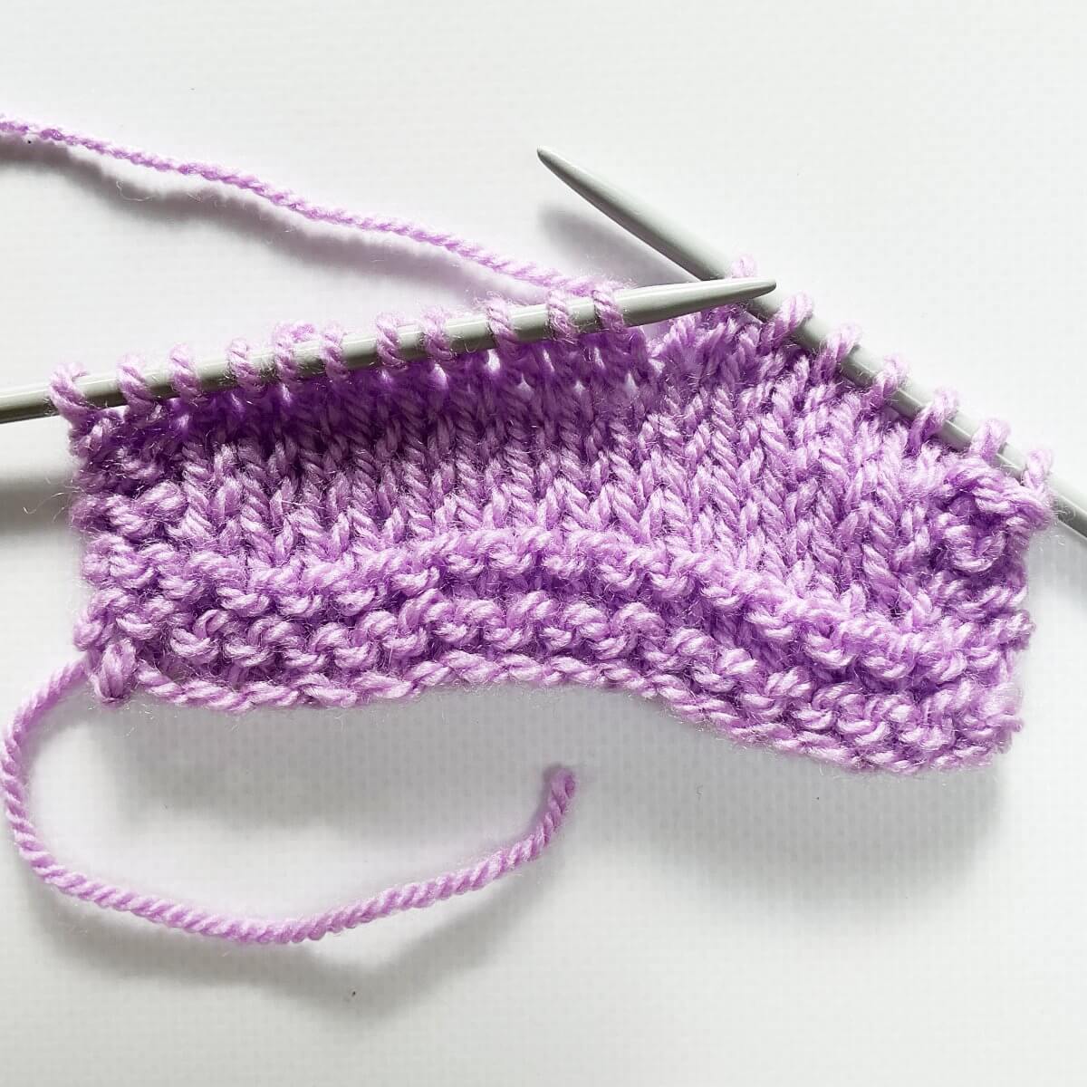 Step 1 of working a sl2-k2tog-p2sso decrease