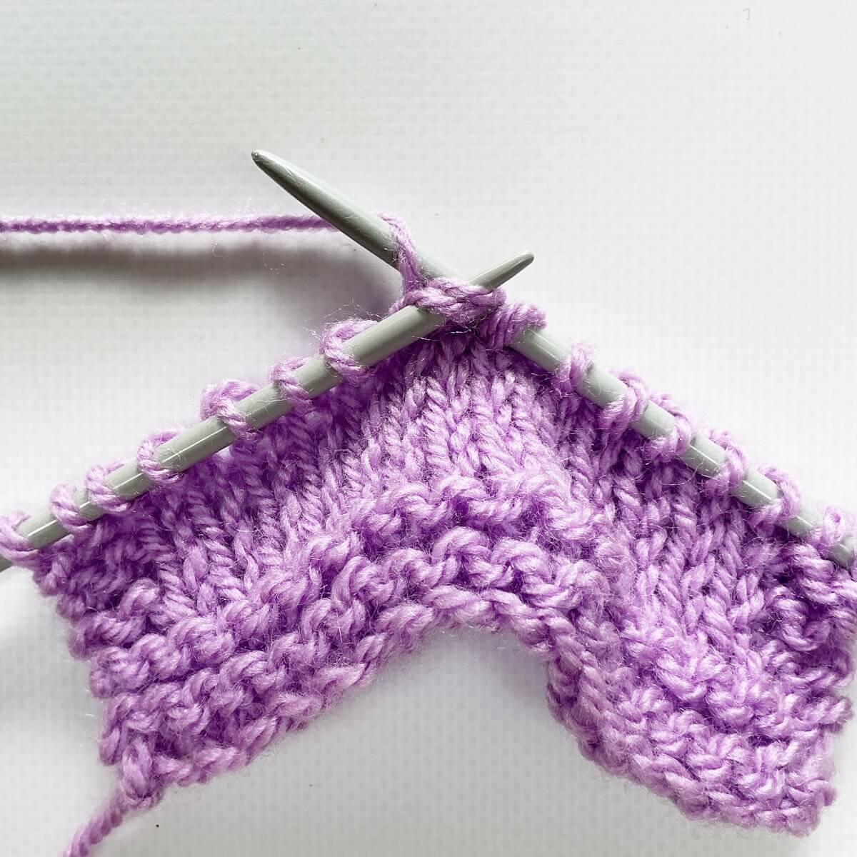 Step 5 of working a sl2-k2tog-p2sso decrease