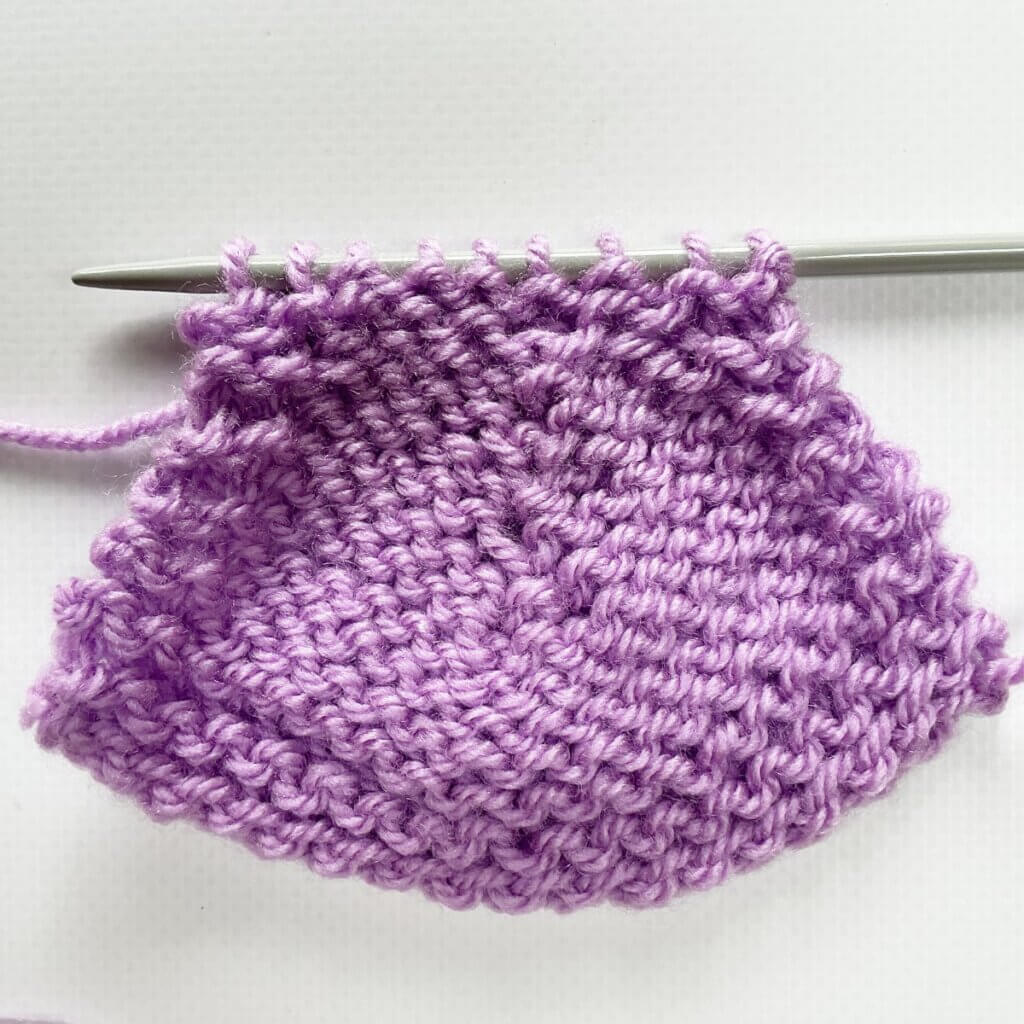 The sl2-k2tog-p2sso left-leaning centered decrease from the WS