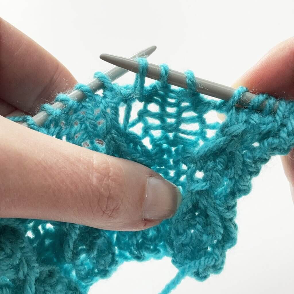 Step 2 - Insert the needle, wrap yarn around and through to pull op a loop