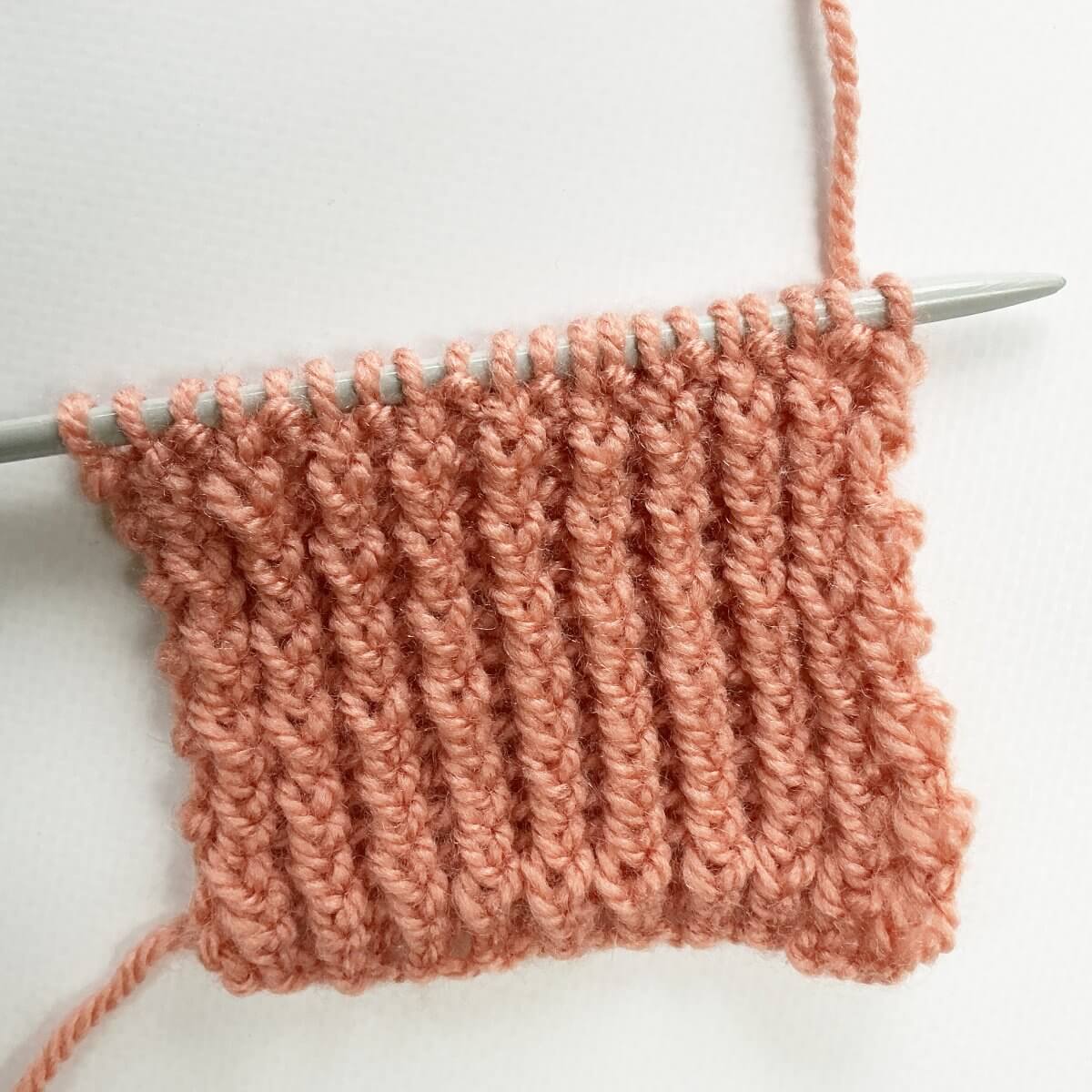 Step 1 of working the stretchy YO bind-off for 1x1 rib.