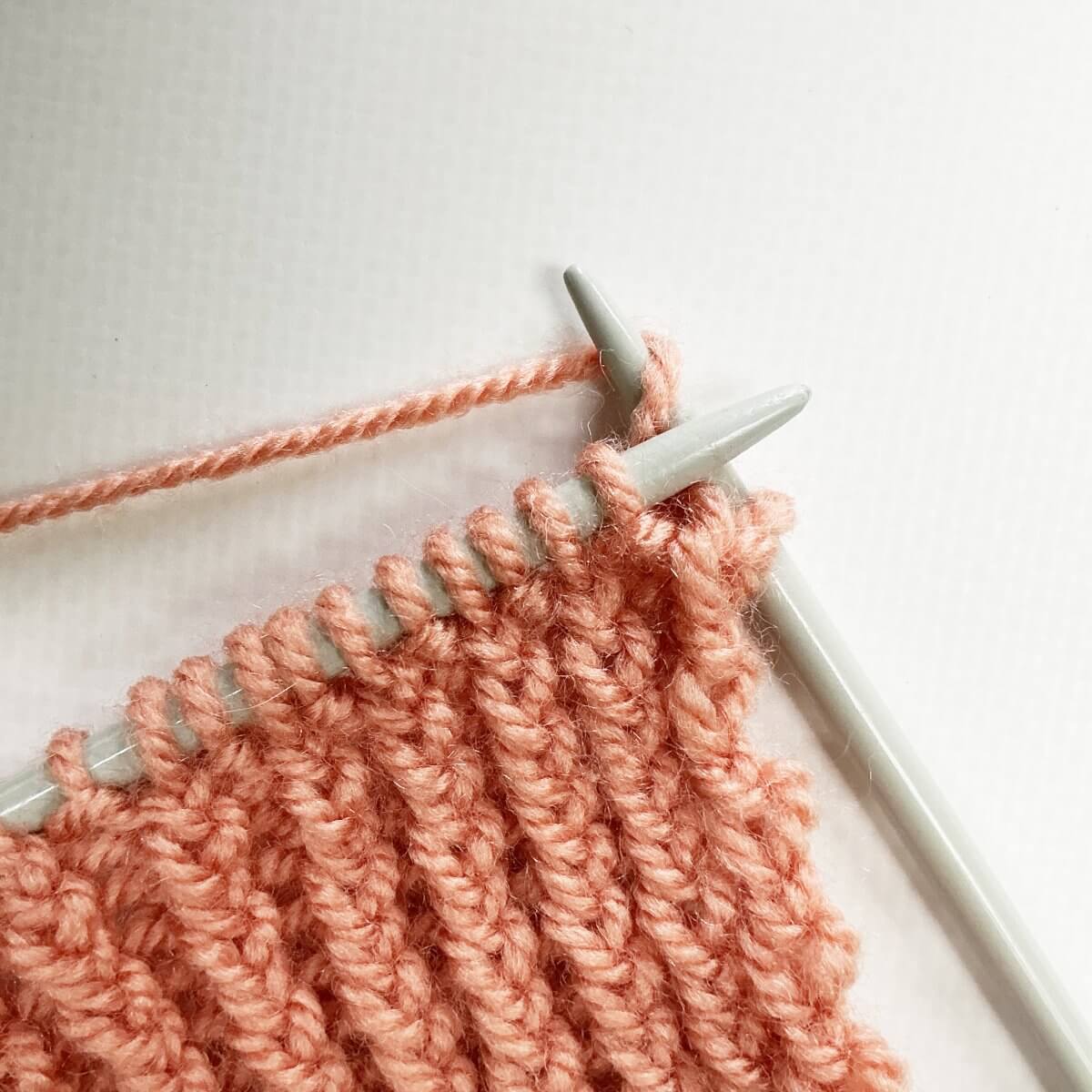 Step 3 of working the stretchy YO bind-off for 1x1 rib.