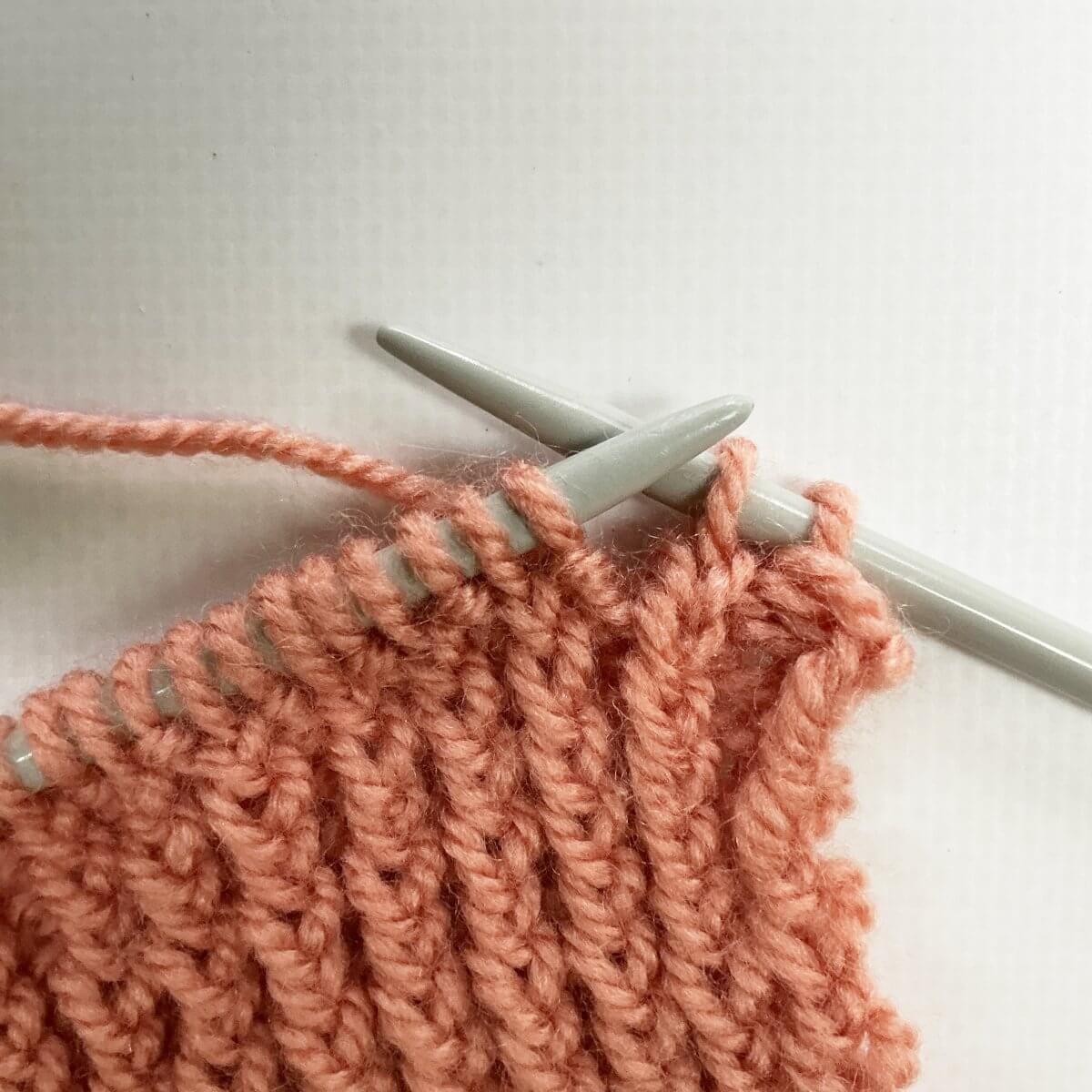 Step 7 of working the stretchy YO bind-off for 1x1 rib.