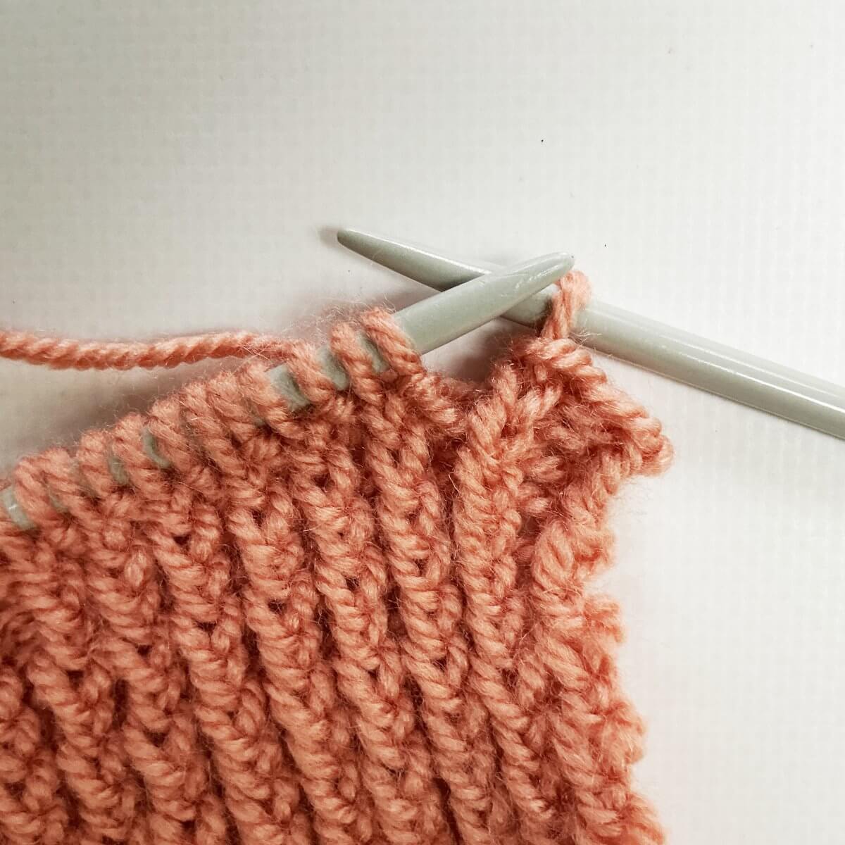 Step 9 of working the stretchy YO bind-off for 1x1 rib.