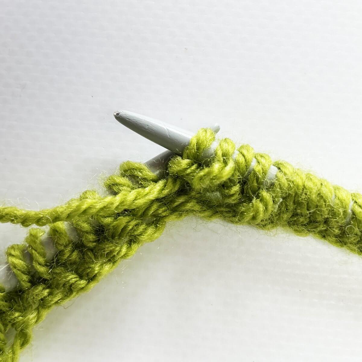 Step 3 of knitting a bobble