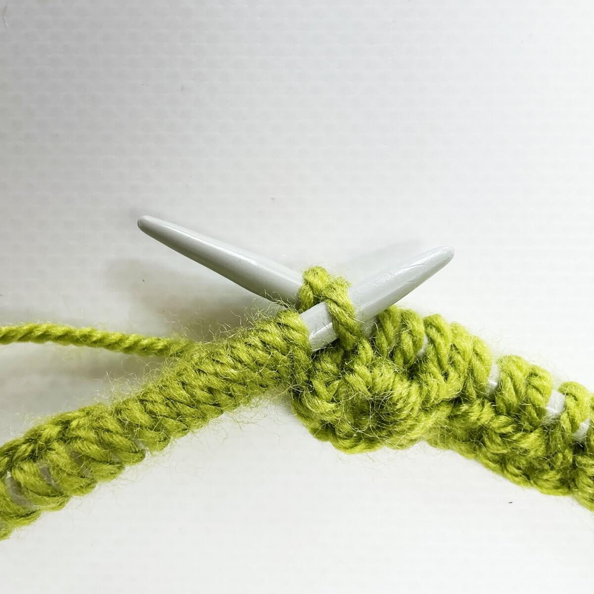 Step 5 of knitting a bobble