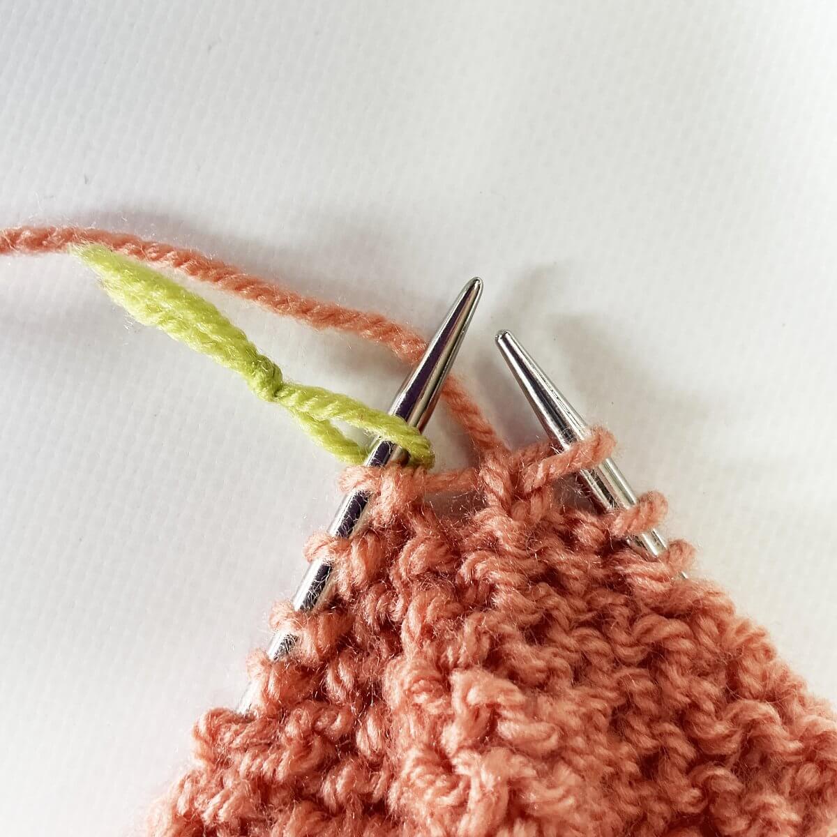 Step 3 of working jog-less garter stitch in the round with the lifted strand & p2tog method