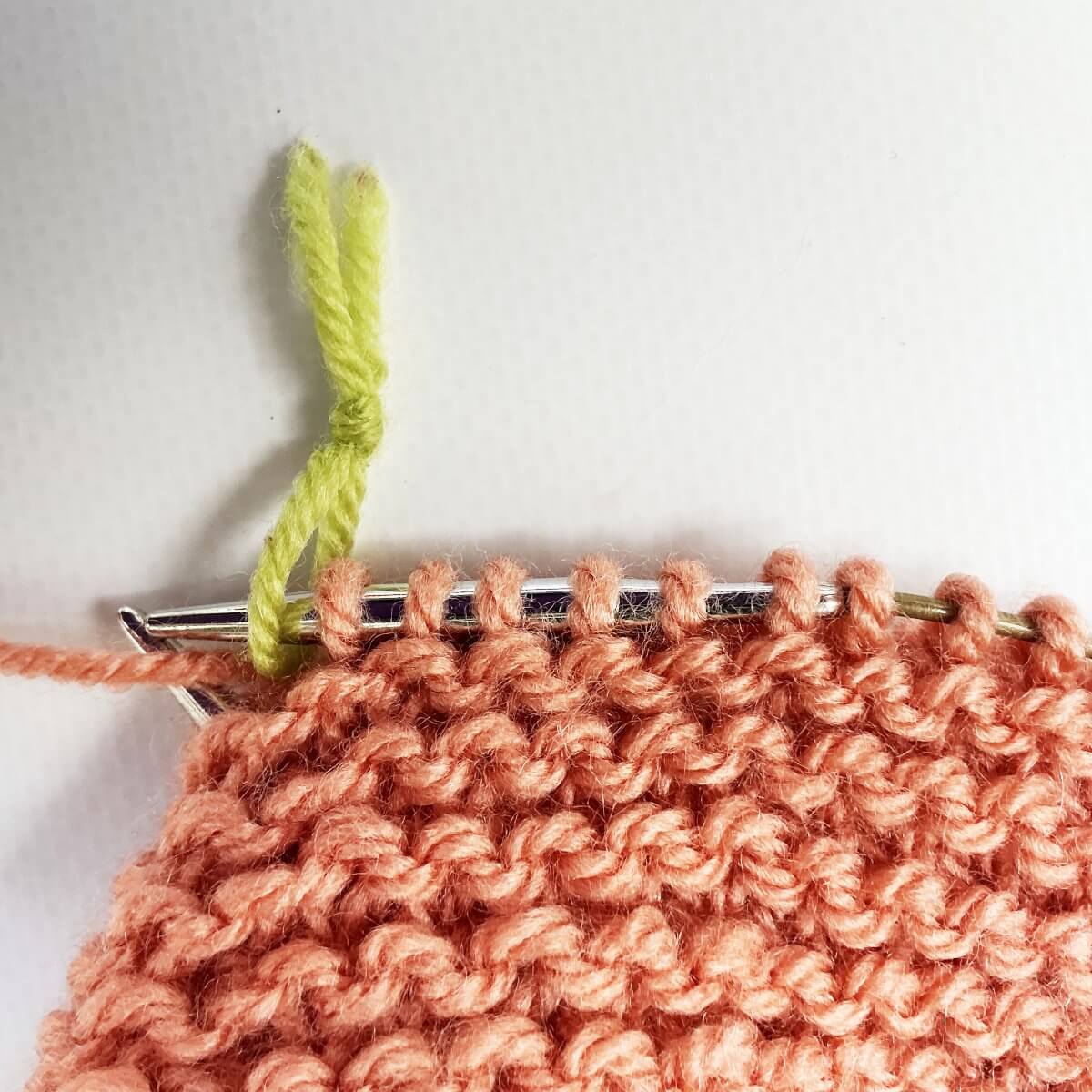 Step 1 of working jog-less garter stitch in the round with the sl1 wyif method